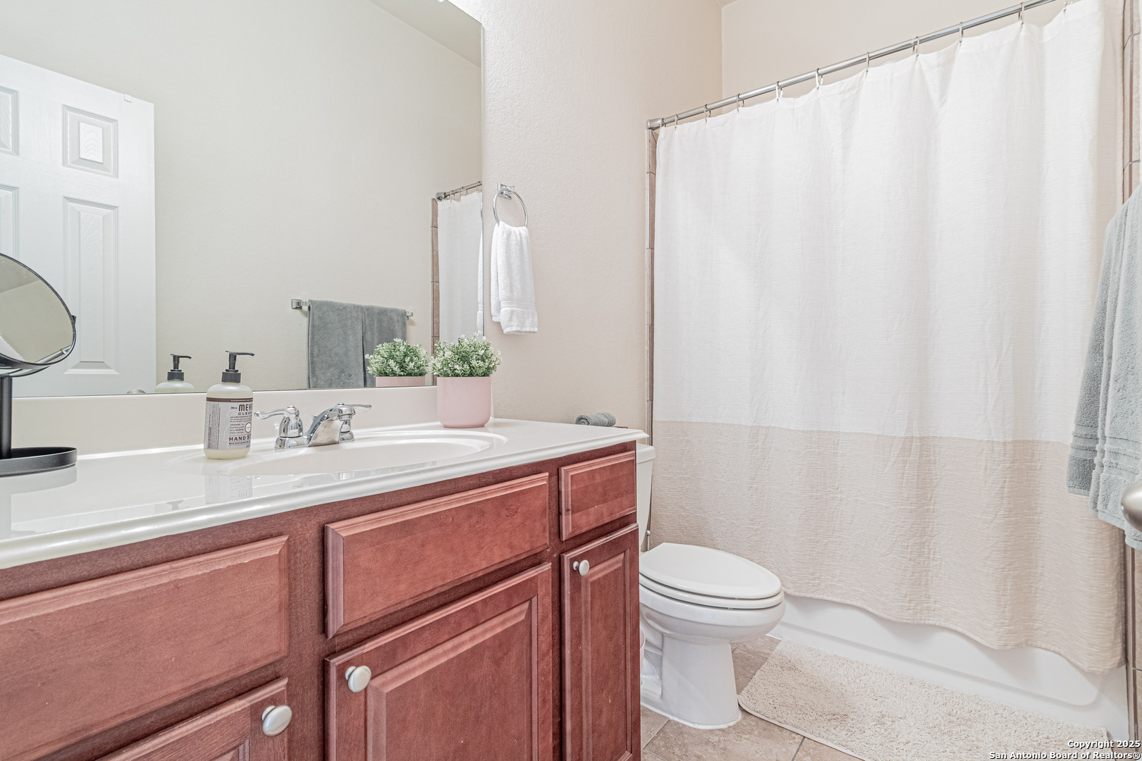 159 Brook View Cibolo, TX 78108 - Photo 21 of 24 a bathroom with a granite countertop sink a toilet and a mirror