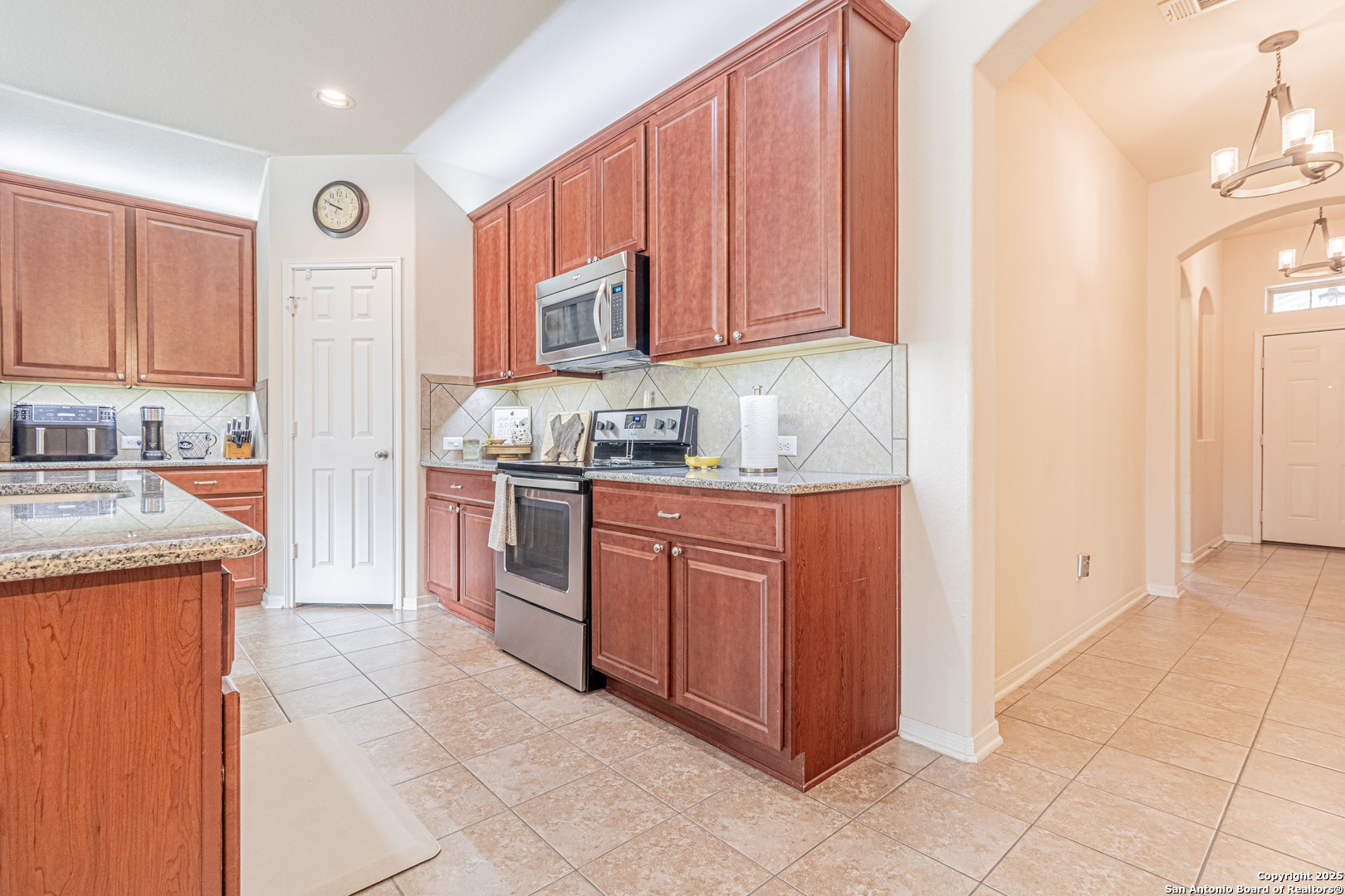 159 Brook View Cibolo, TX 78108 - Photo 6 of 24 a kitchen with stainless steel appliances granite countertop a stove a sink and a refrigerator