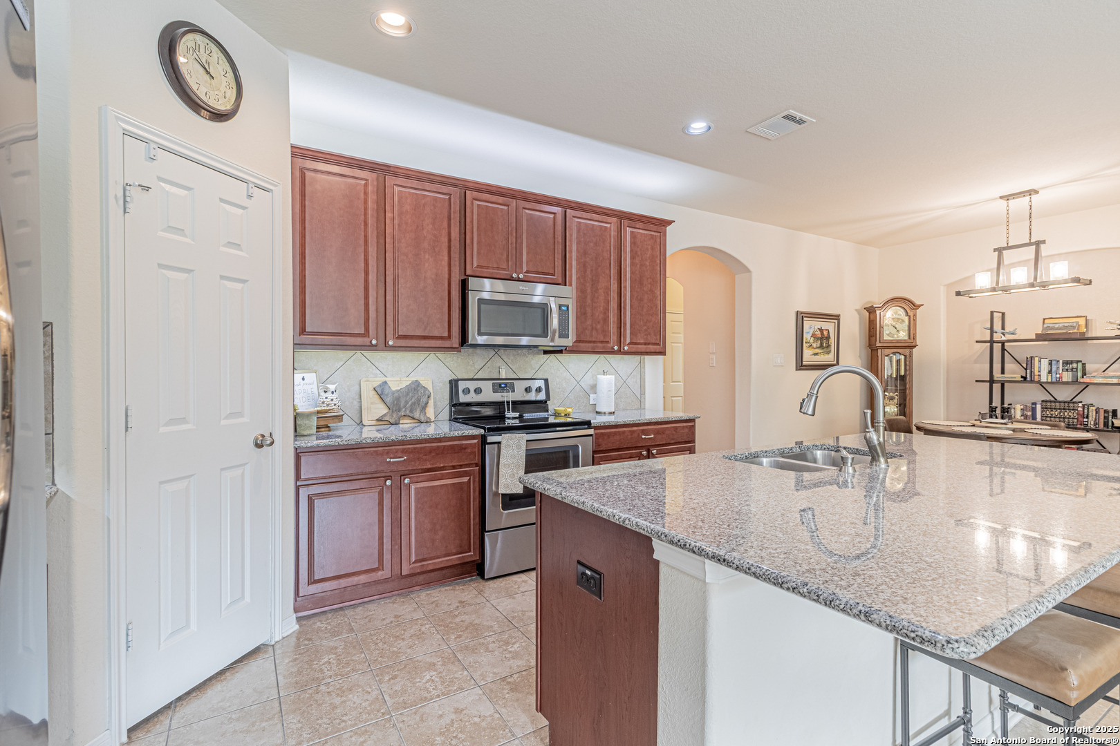 159 Brook View Cibolo, TX 78108 - Photo 7 of 24 a kitchen with kitchen island granite countertop a sink cabinets and stainless steel appliances