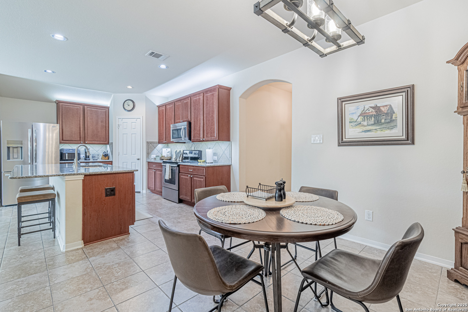 159 Brook View Cibolo, TX 78108 - Photo 8 of 24 a kitchen with stainless steel appliances a table and chairs