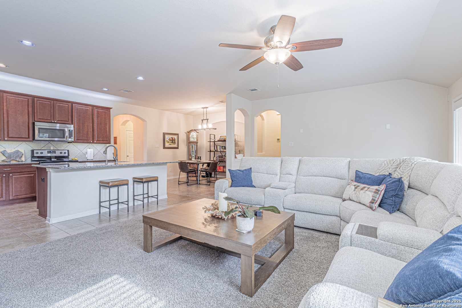 159 Brook View Cibolo, TX 78108 - Photo 10 of 24 a living room with furniture kitchen view and a chandelier