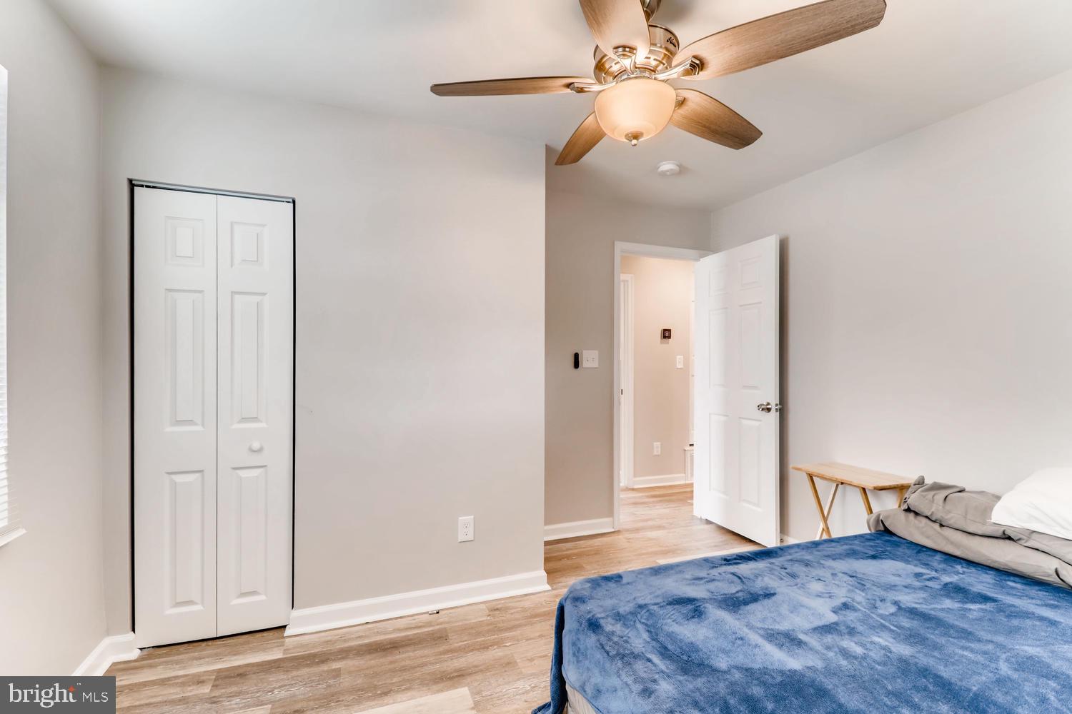 3413 Kimble Road Windsor Mill, MD 21244 - Photo 14 of 28 a bedroom with a bed and a chandelier fan