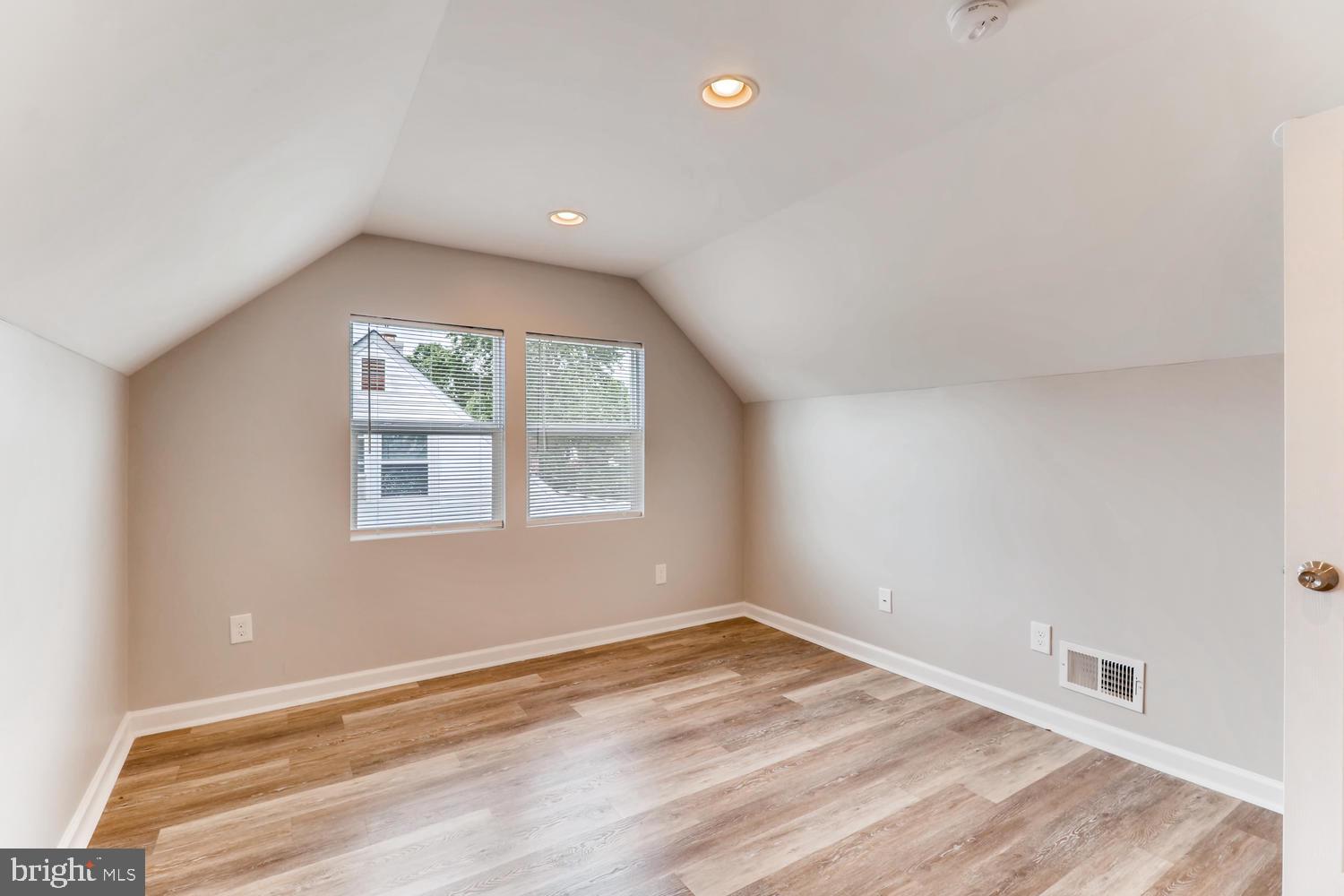 3413 Kimble Road Windsor Mill, MD 21244 - Photo 15 of 28 an empty room with wooden floor and windows