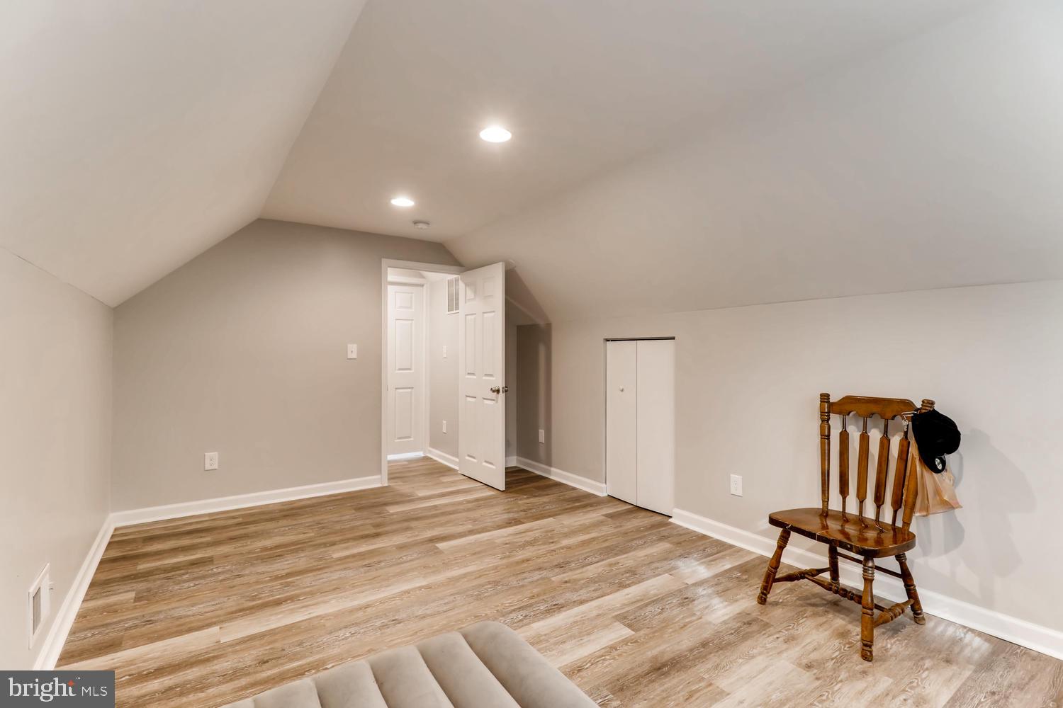 3413 Kimble Road Windsor Mill, MD 21244 - Photo 21 of 28 a view of an empty room with wooden floor and chair