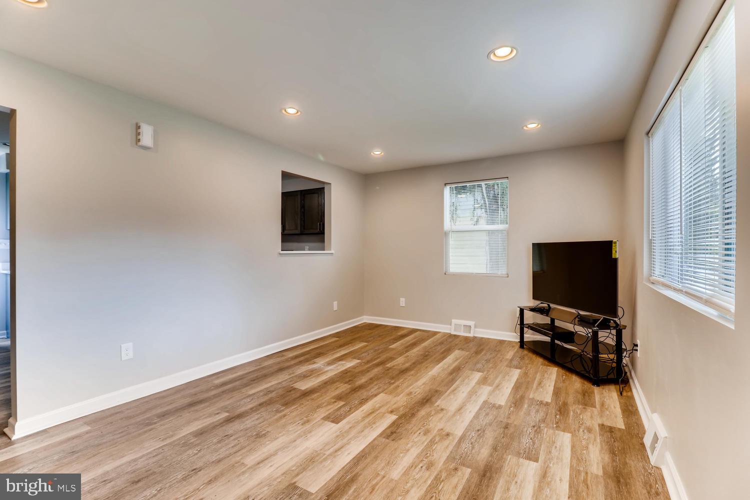 3413 Kimble Road Windsor Mill, MD 21244 - Photo 5 of 28 a view of a livingroom with wooden floor and a flat screen tv
