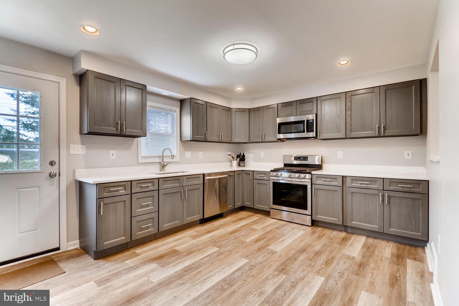 3413 Kimble Road Windsor Mill, MD 21244 - Photo 6 of 28 a kitchen with stainless steel appliances granite countertop a stove sink and cabinets