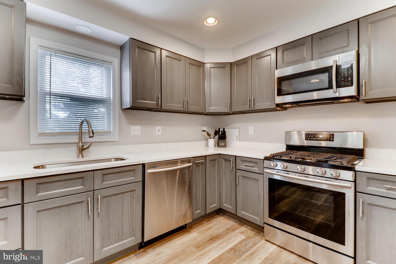 3413 Kimble Road Windsor Mill, MD 21244 - Photo 8 of 28 a kitchen with cabinets stainless steel appliances a sink and a microwave