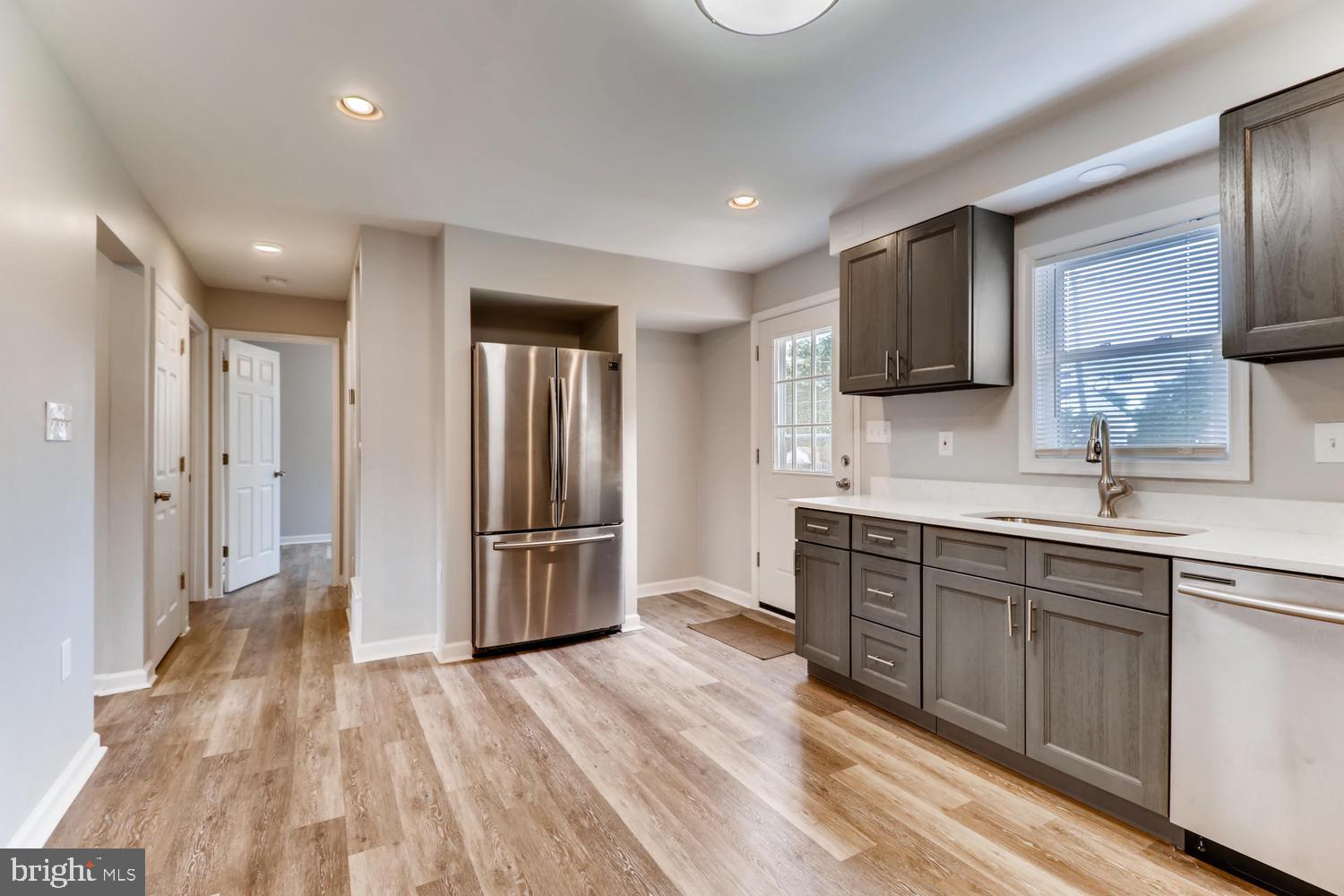 3413 Kimble Road Windsor Mill, MD 21244 - Photo 9 of 28 a large kitchen with a sink and stainless steel appliances