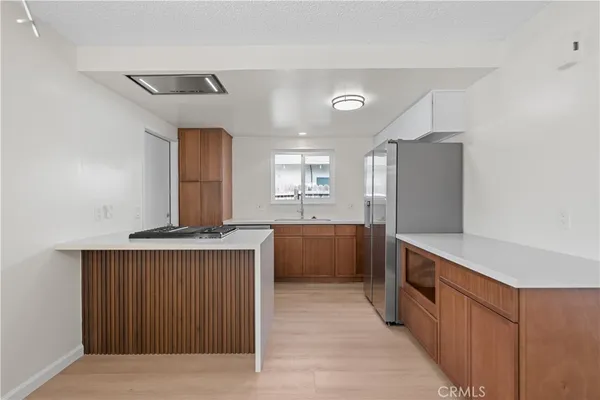 a kitchen with stainless steel appliances a stove and a refrigerator