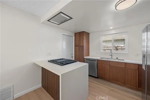 a kitchen that has a sink and a stove in it