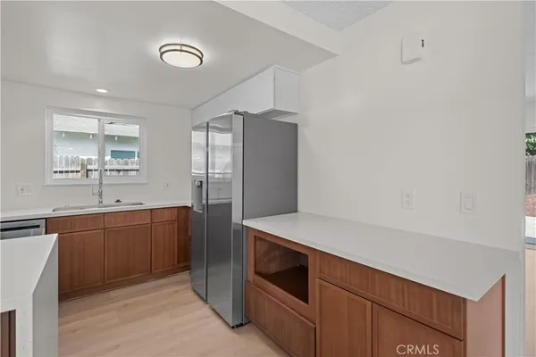 a kitchen with stainless steel appliances a refrigerator and a sink