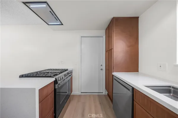 a kitchen that has a sink and a stove
