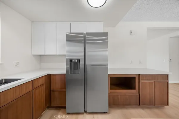 a kitchen with cabinets and stainless steel appliances