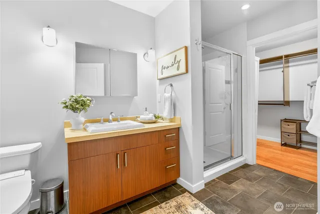 a bathroom with a sink mirror vanity and toilet
