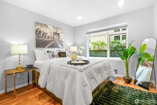 a bed sitting in a bedroom next to a window