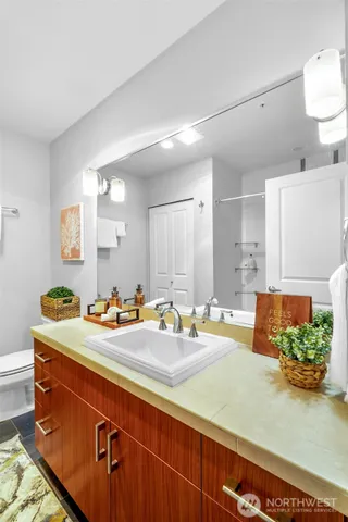 a room with a sink a bed and a couch