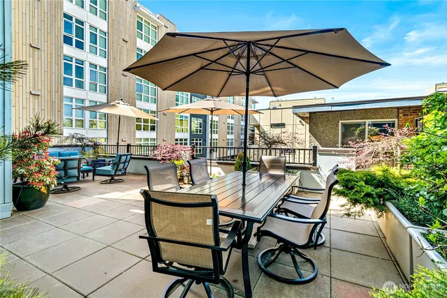 a patio table and chairs under an umbrella