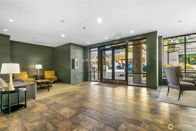 a lobby with furniture and floor to ceiling window