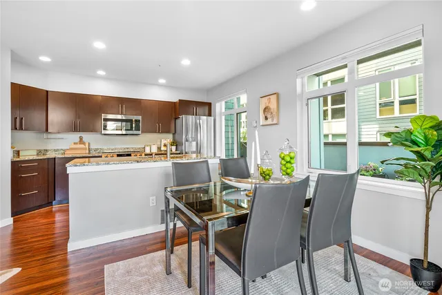 a view of a dining room with furniture window and wooden floor