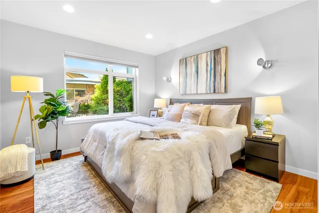 a bed sitting in a bedroom next to a window