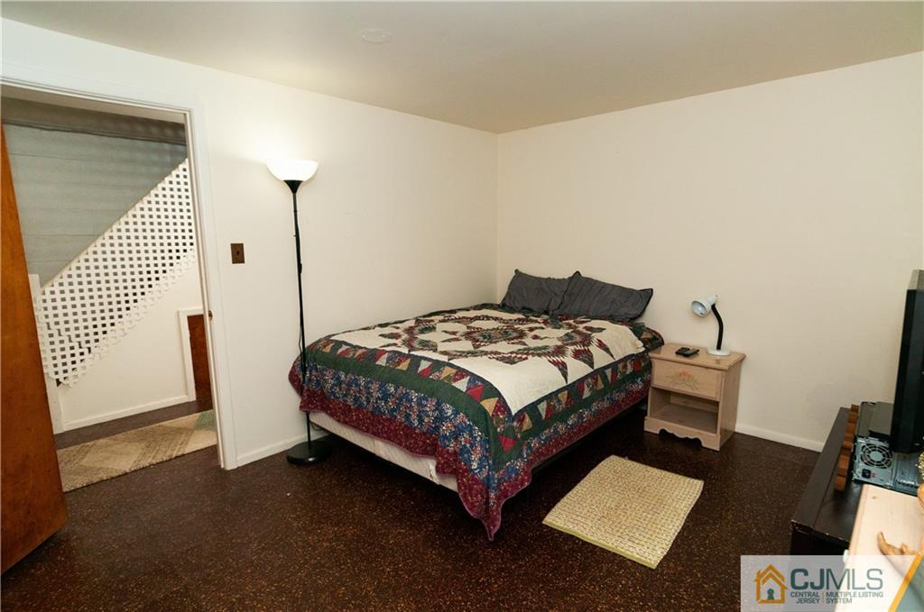 18 Rutgers Road Old Bridge, NJ 08859 - Photo 24 of 30 a bedroom with a bed lamp and a mirror