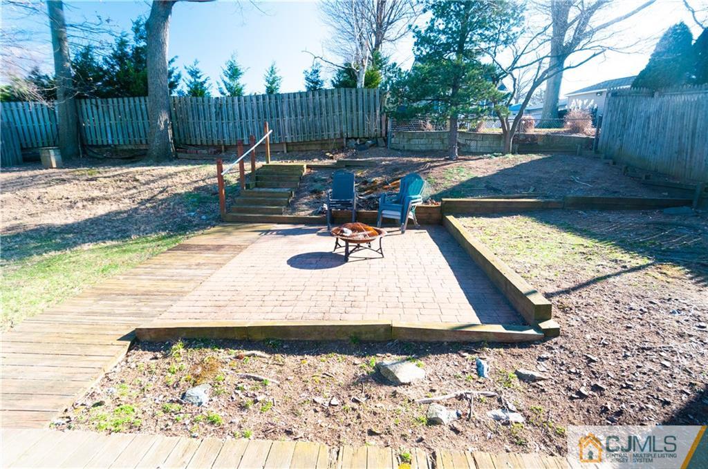 18 Rutgers Road Old Bridge, NJ 08859 - Photo 30 of 30 a view of a wooden deck with chair and tables