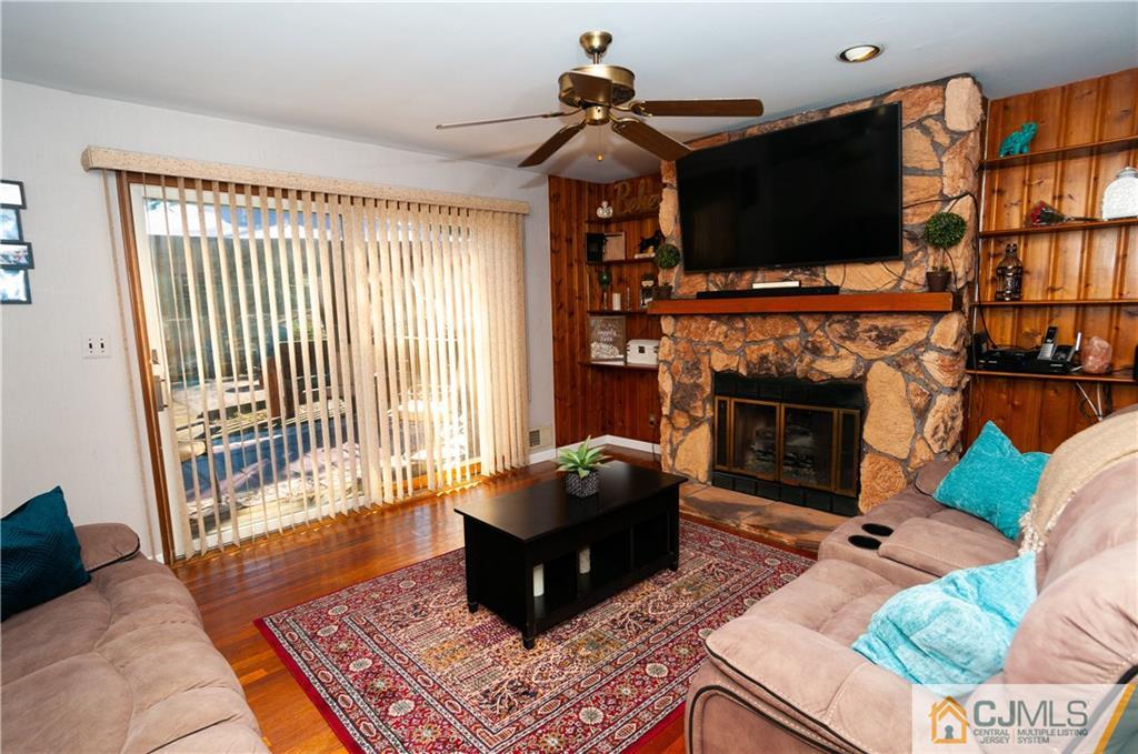 18 Rutgers Road Old Bridge, NJ 08859 - Photo 6 of 30 a living room with furniture a flat screen tv and a fireplace