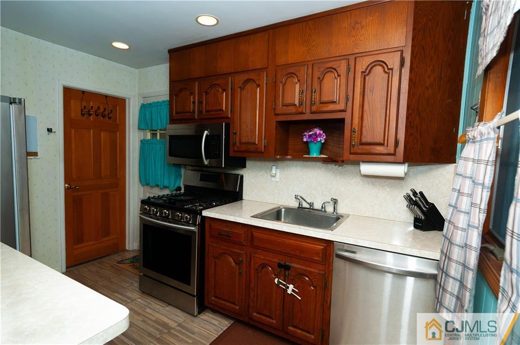 18 Rutgers Road Old Bridge, NJ 08859 - Photo 10 of 30 a kitchen with stainless steel appliances granite countertop a refrigerator stove and sink