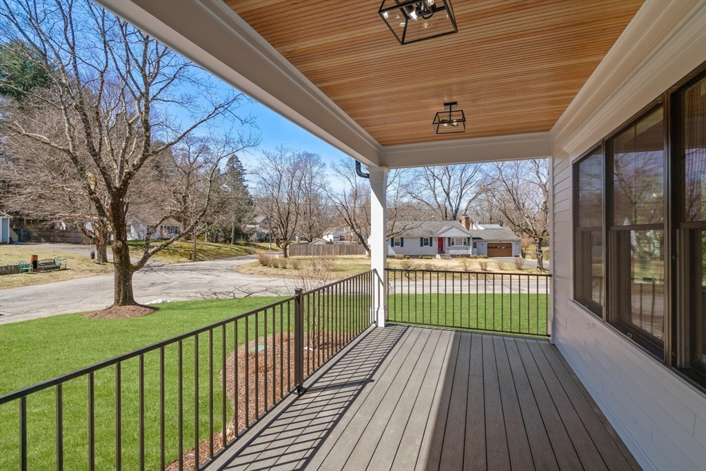 81 Powers Road Concord, MA 01742 - Photo 3 of 10 a view of a porch with wooden floor and fence