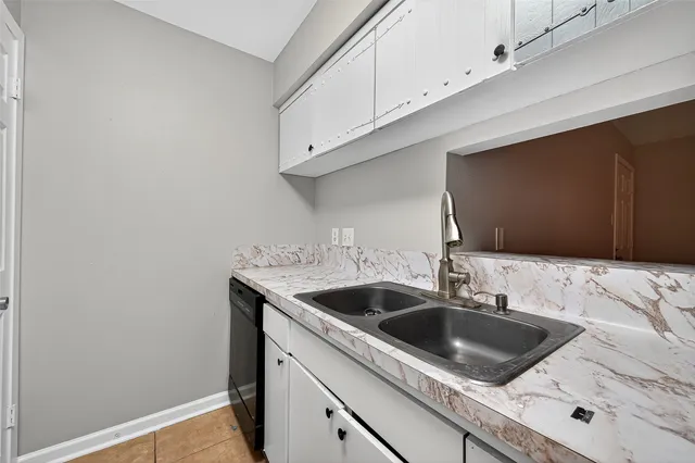 a kitchen with a sink and cabinets