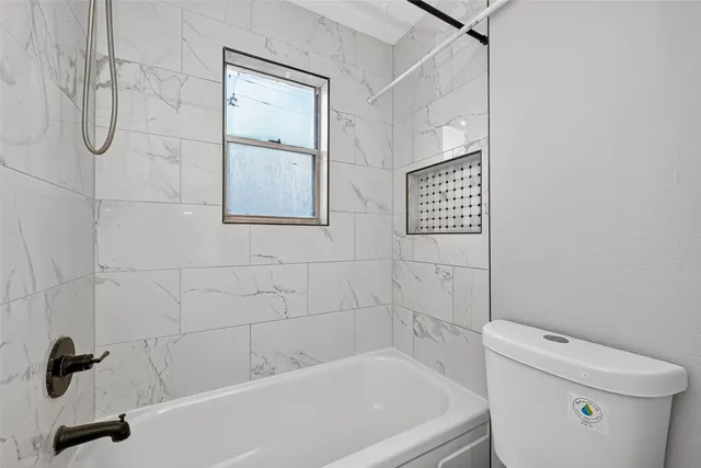 a bathroom with a shower and a toilet