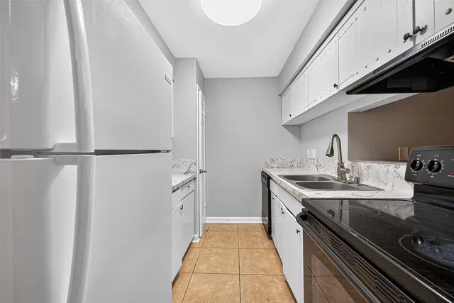 a kitchen with stainless steel appliances granite countertop a sink and cabinets