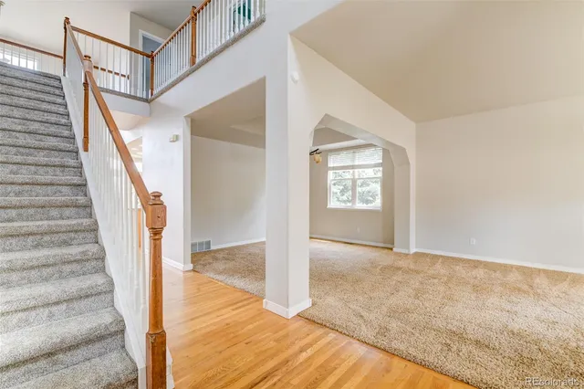 a view of kitchen with stainless steel appliances kitchen island wooden floors and large window