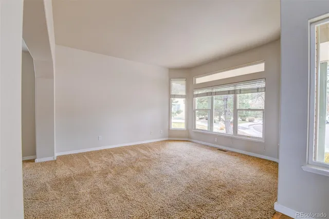 a kitchen with stainless steel appliances granite countertop a refrigerator a stove and white cabinets with wooden floor