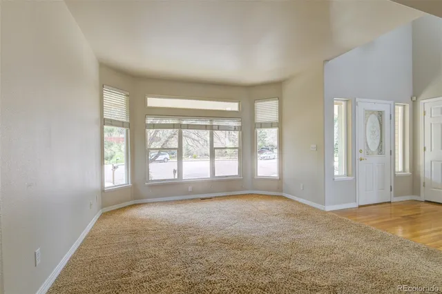 a view of a kitchen with kitchen island wooden floor and stainless steel appliances