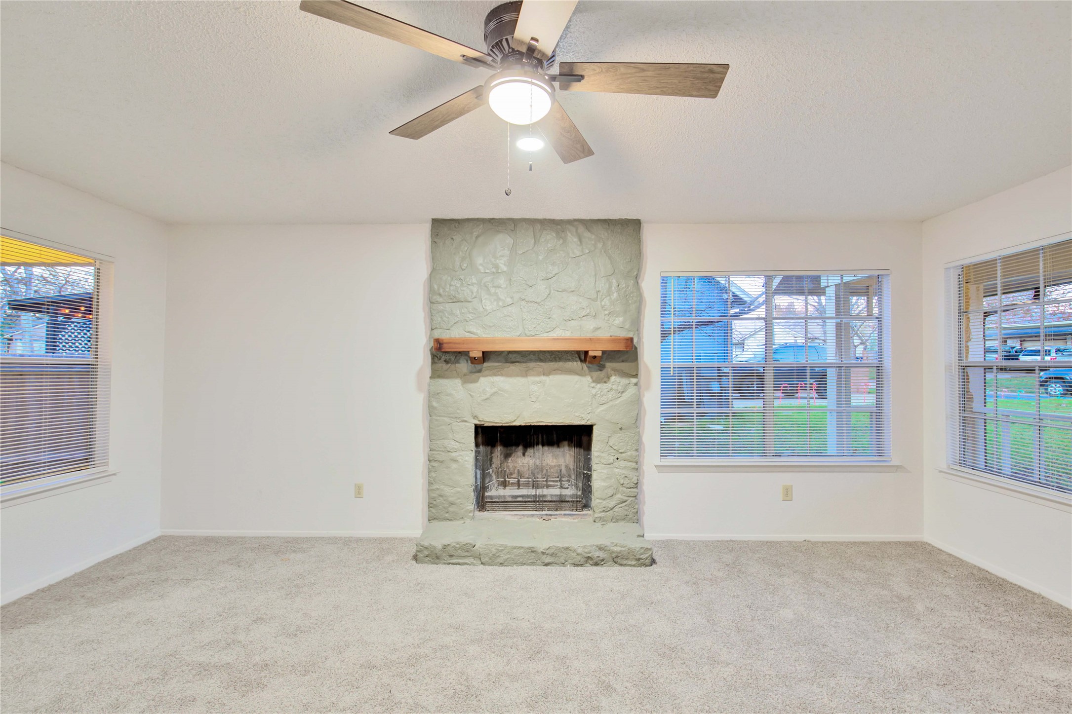 2807 Firecrest Drive Austin, TX 78748 - Photo 7 of 30 an empty room with windows and fireplace