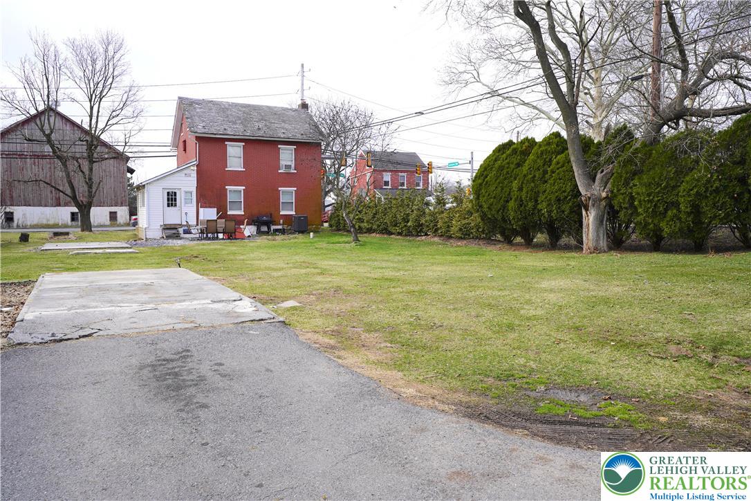3863 Mauch Chunk Road Coplay, PA 18037 - Photo 28 of 33 a view of a big room with a big yard and large trees