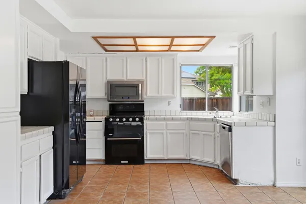 a kitchen with stainless steel appliances a refrigerator stove and sink