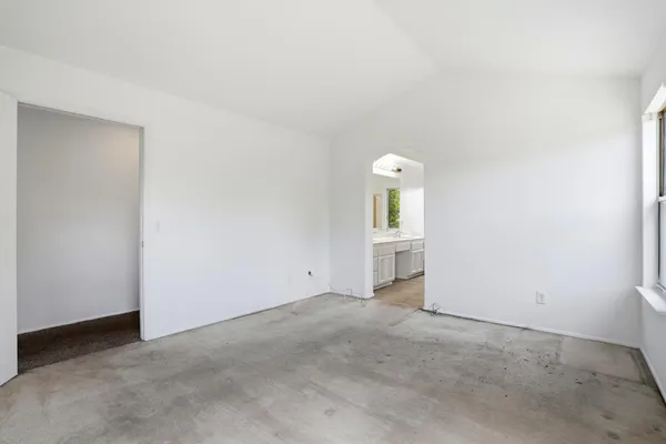 an empty room with windows and closet
