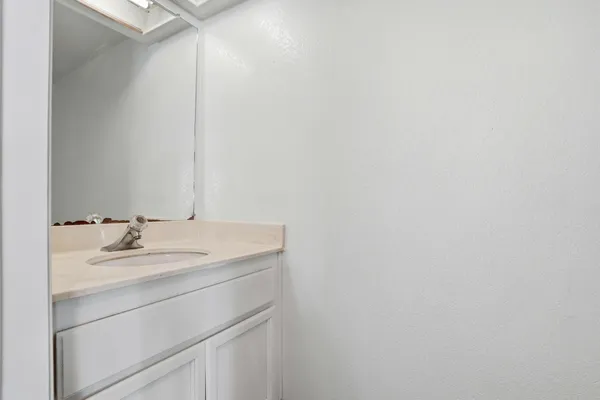 a bathroom with a sink a vanity and a bathtub