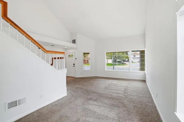 a view of a big room with windows and stairs