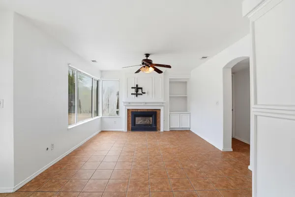 a view of a livingroom with a fireplace and window