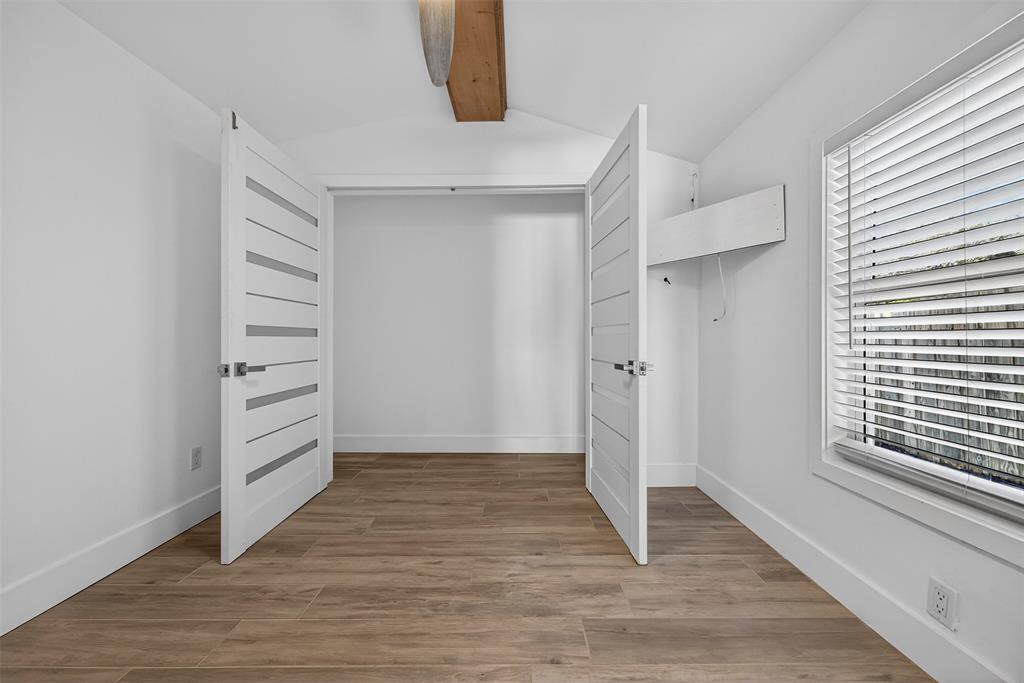 181 Northeast 15th Terrace Boca Raton, FL 33431 - Photo 23 of 51 a view of an empty room with a window and wooden floor