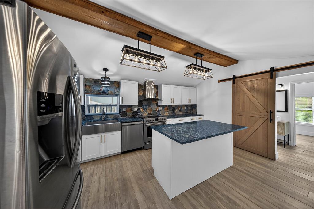 181 Northeast 15th Terrace Boca Raton, FL 33431 - Photo 28 of 51 a kitchen with stainless steel appliances granite countertop a refrigerator a stove and a wooden floors