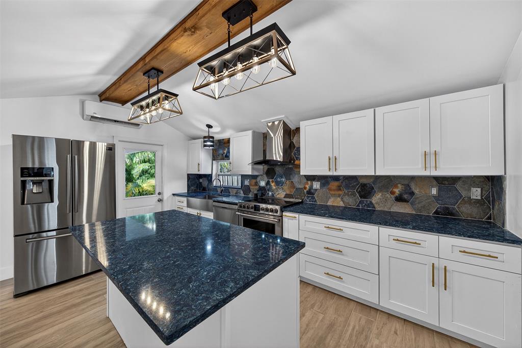 181 Northeast 15th Terrace Boca Raton, FL 33431 - Photo 30 of 51 a kitchen with stainless steel appliances granite countertop a sink a stove and cabinets