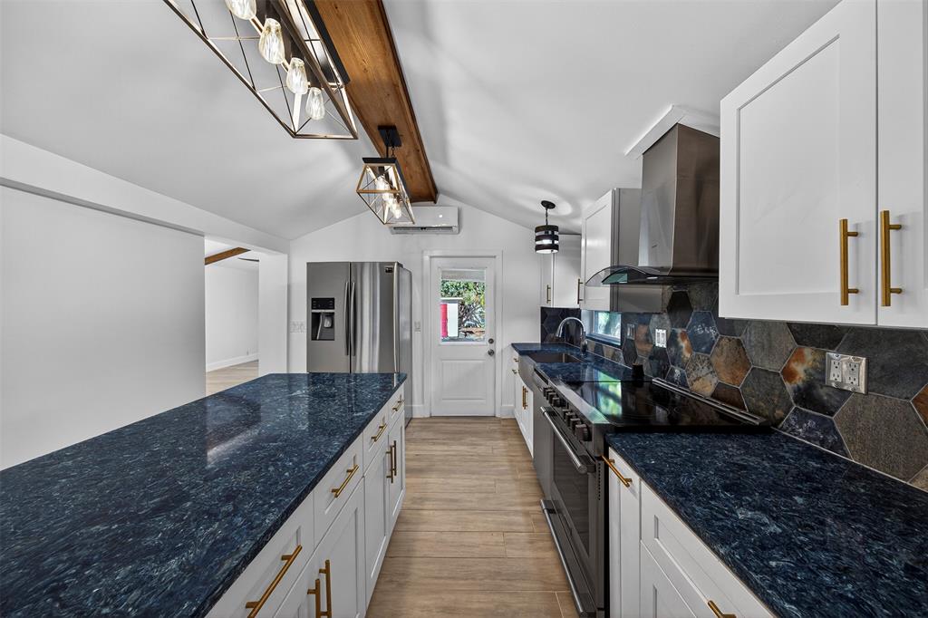 181 Northeast 15th Terrace Boca Raton, FL 33431 - Photo 31 of 51 a open kitchen with stainless steel appliances granite countertop a sink stove and refrigerator