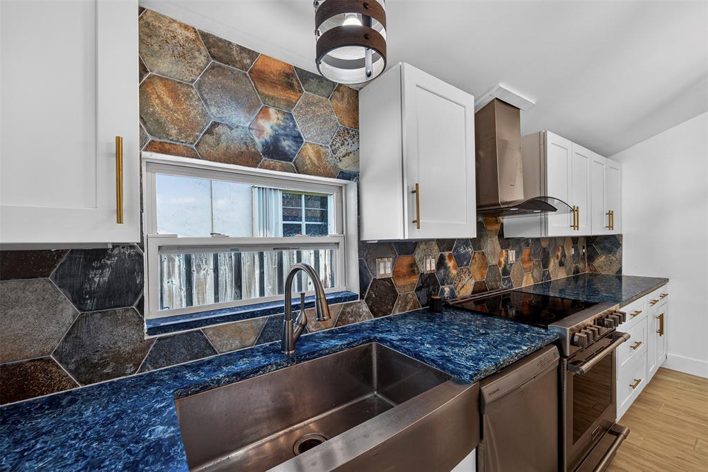181 Northeast 15th Terrace Boca Raton, FL 33431 - Photo 33 of 51 a kitchen with granite countertop a stove and a sink