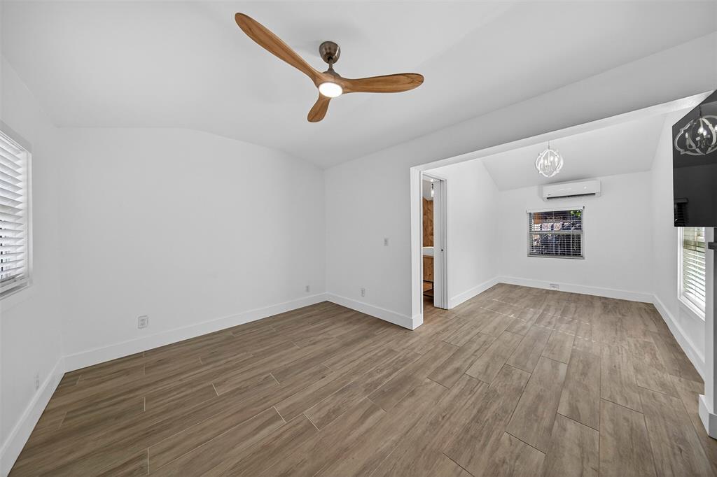 181 Northeast 15th Terrace Boca Raton, FL 33431 - Photo 34 of 51 an empty room with wooden floor and windows