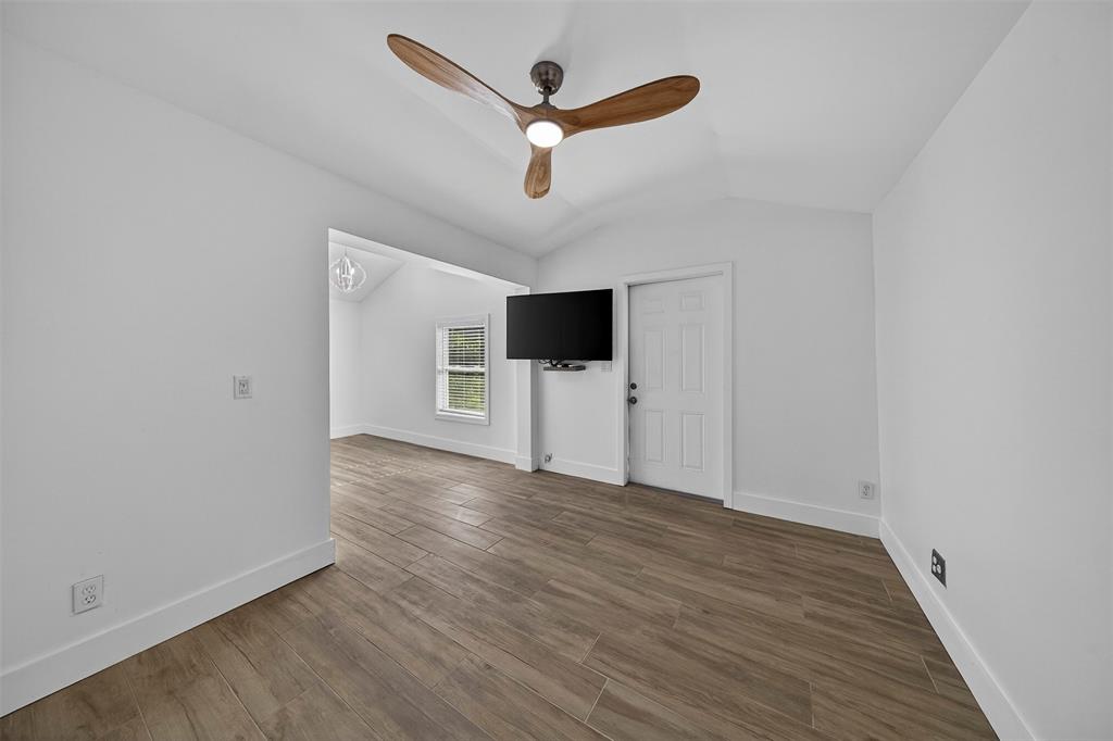 181 Northeast 15th Terrace Boca Raton, FL 33431 - Photo 35 of 51 an empty room with wooden floor and a ceiling fan