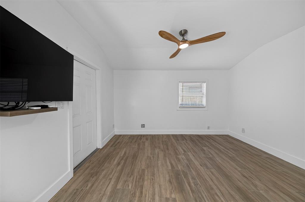 181 Northeast 15th Terrace Boca Raton, FL 33431 - Photo 36 of 51 a view of a room with wooden floor and a ceiling fan